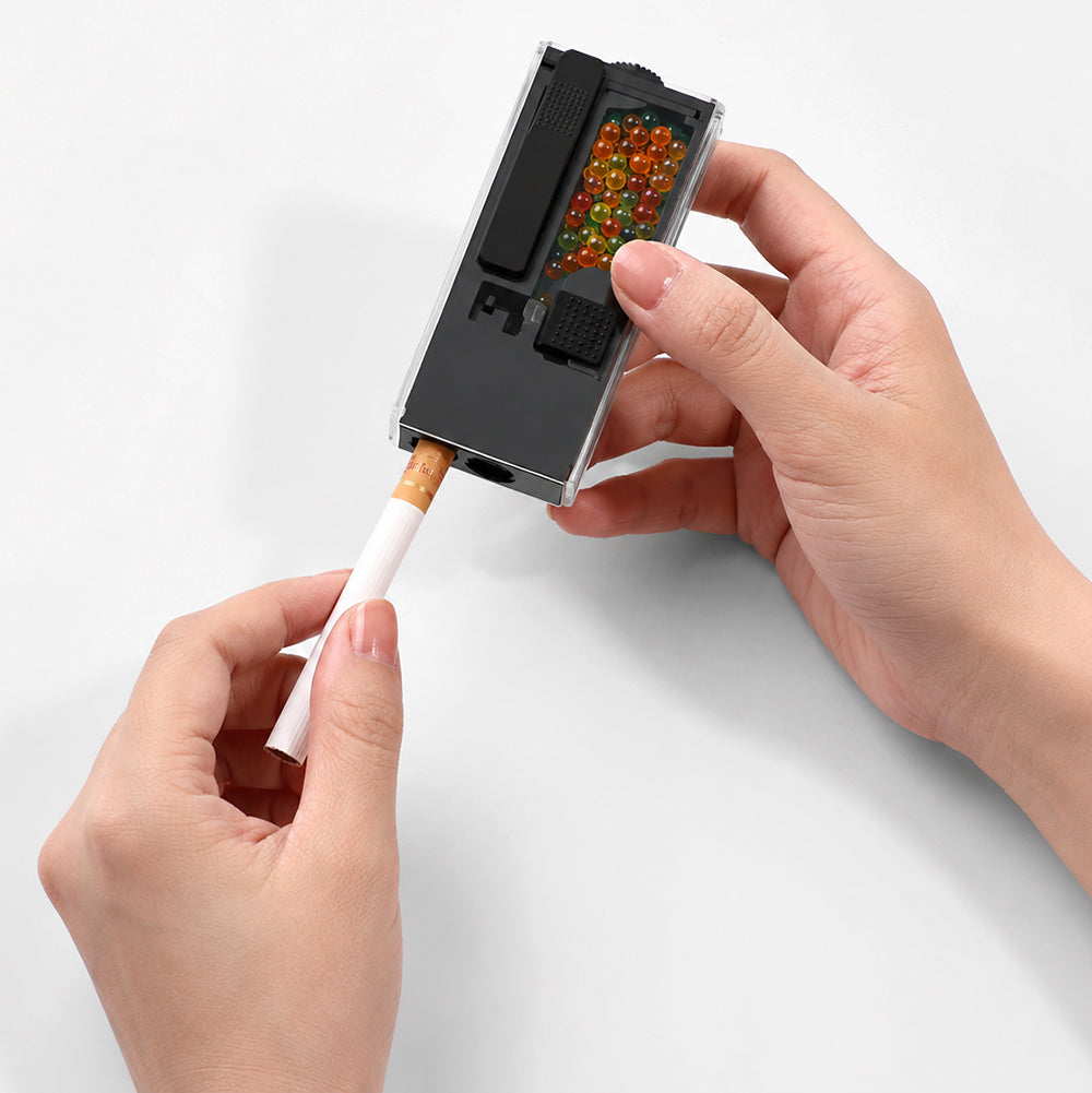 hands holding All Star Poppers Black Stealth Applicator inserting crush balls into cigarette